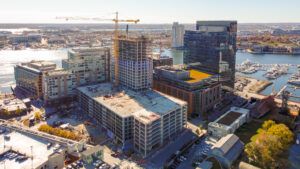 Aerial view of the high-rise Parcel 4 building under development at Baltimore's Harbor Point, surrounded by urban scenery