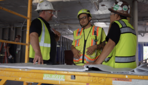 robey drywall employees wearing safety vests and oshas required safety helmets