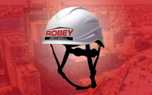 white safety helmet with the robey drywall logo that follows osha guidelines